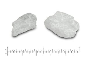 Two white chunks of crystallized methamphetamine to scale