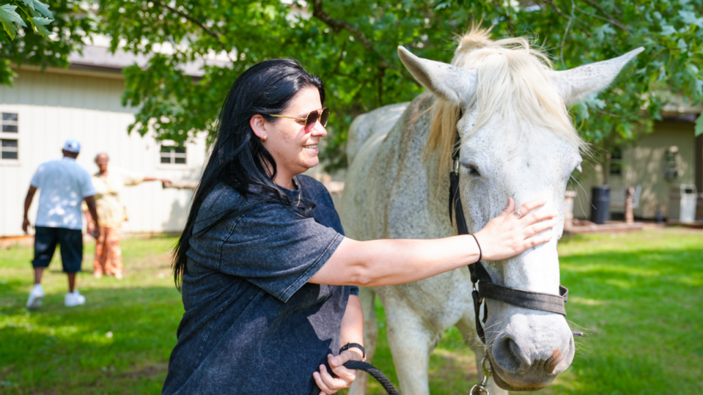Alumni gathering featuring on of our many horses used in equine therapy