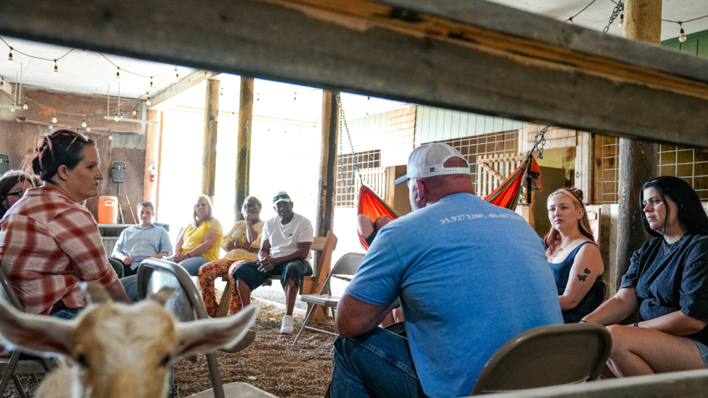 Alumni having a meeting in the barn at JourneyPure
